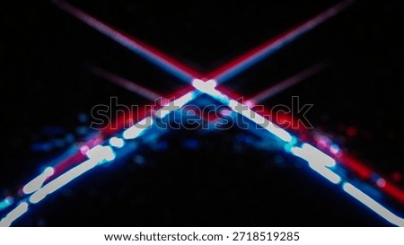 A mesmerizing display of intersecting light trails in shades of red, blue, and white against a dark background with subtle hints of color