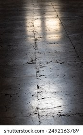 A mesmerizing interplay of light and shadow dances across the ancient stone floor of a grand Catholic cathedral.