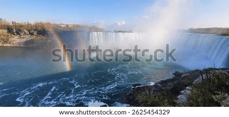 A mesmerizing panoramic view of the double rainbow over the Niagara Falls
