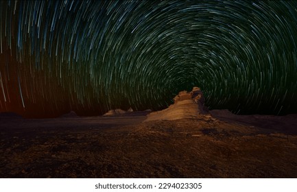 A mesmerizing photo of a starry sky, with the Star Trail shining brightly above an ancient tomb in the background.