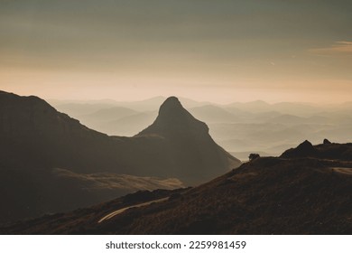 A mesmerizing shot of the golden hour, the silhouette of foggy mountains in Durmitor, Montenegro