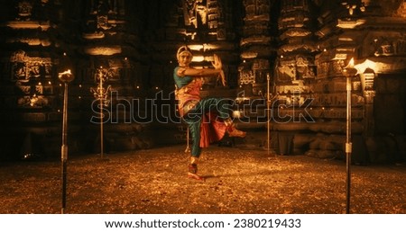 Mesmerizing Slow-Motion Portrait of Female Indian Dancer Expressing Herself Through Captivating Folk Dance Choreography Inside an Ancient Temple. She Wears Traditional Clothes and Dances Bharatanatyam