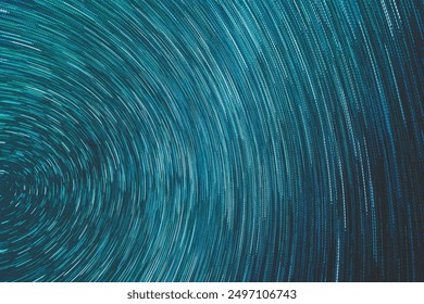 A mesmerizing star trails image created from a combination of 100 long-exposure photos. The sky is filled with concentric arcs of starlight, showcasing the Earth's rotation in a celestial dance.