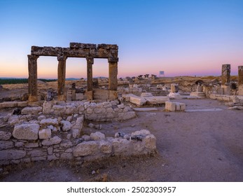  A mesmerizing view of the ancient ruins of Blaundus captured during twilight. The soft hues of the sunset create a serene backdrop, highlighting the historical significance of the stone structures. - Powered by Shutterstock