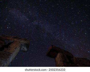 A mesmerizing view of the ancient ruins of Blaundus captured during twilight. The soft hues of the sunset create a serene backdrop, highlighting the historical significance of the stone structures. - Powered by Shutterstock