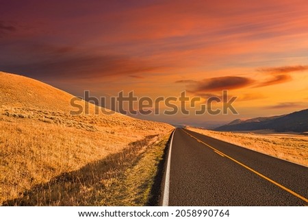A mesmerizing view of empty asphalt road during a breathtaking sunset