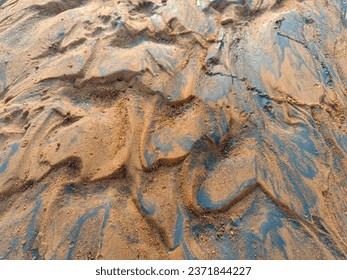 A mesmerizing view of intricate wet river sand patterns, a testament to the artistry of water and earth.