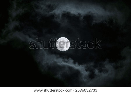 A mesmerizing view of a moon in the dark cloudy sky
