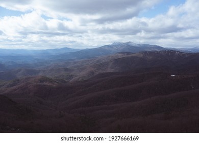 A mesmerizing view of mountain ranges under a cloudy sky