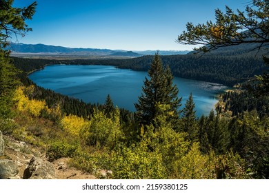 A mesmerizing view of Phelps Lake in Wyoming and the Tetons national park with green trees