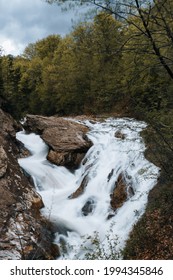 A mesmerizing view of the Putna Cascade of the mountain river flowing through a forest
