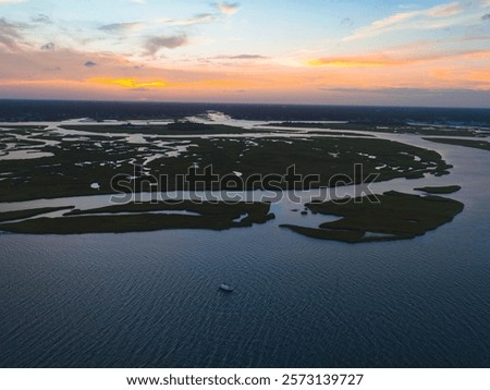 A mesmerizing view of a river and a boat in the water at scenic sunset in Wrightsville Beach, NC