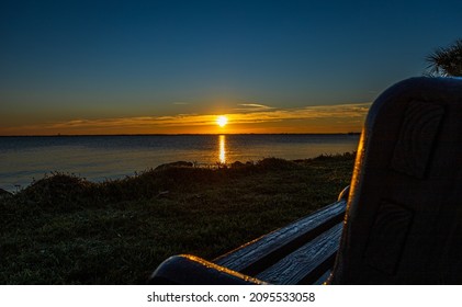 A mesmerizing view of a sunset at the seaside reflected on a water