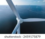 A mesmerizing view of windmill turbines generating clean energy in the vast expanse of the ocean, representing a harmonious blend of technology and nature.