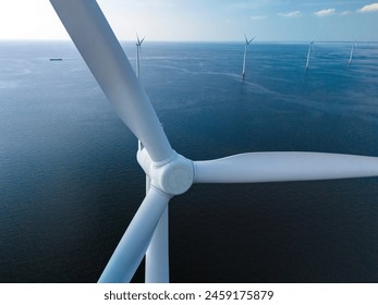 A mesmerizing view of windmill turbines generating clean energy in the vast expanse of the ocean, representing a harmonious blend of technology and nature.
