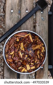 Mesquite Wood Chips Soaking For Smoking Meat On Barbecue. Barbeque Hickory Chunks Soaked For Grilling.