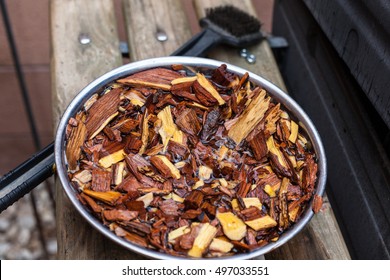 Mesquite Wood Chips Soaking For Smoking Meat On Barbecue. Barbeque Hickory Chunks Soaked For Grilling.