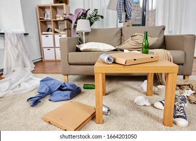 mess, disorder and interior concept - view of messy home living room with scattered stuff - Shutterstock ID 1664201050