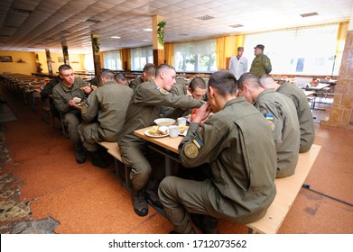 At A Mess Hall: Soldiers Sitting At Set-out Tables And Eating. Novo-Petrivtsi Military Base, Ukraine. November 12, 2018