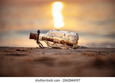 Message in the bottle against the Sun setting down