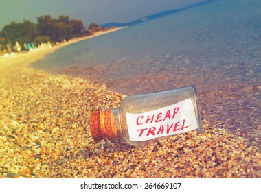 Message in a bottle Cheap travel on beach. Creative summer break and tourism concept.