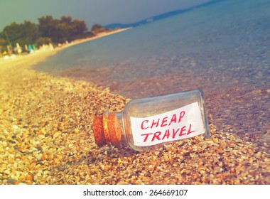 Message In A Bottle Cheap Travel On Beach. Creative Summer Break And Tourism Concept.