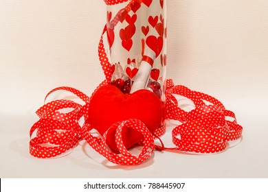 A Message In The Bottle With Harts On It And A Red Ribbon Around It And Red Hart