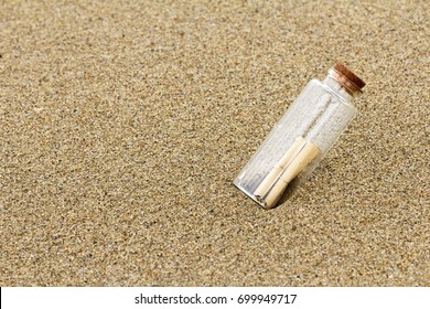 Message in a bottle on beach/Summer background - Shutterstock ID 699949717