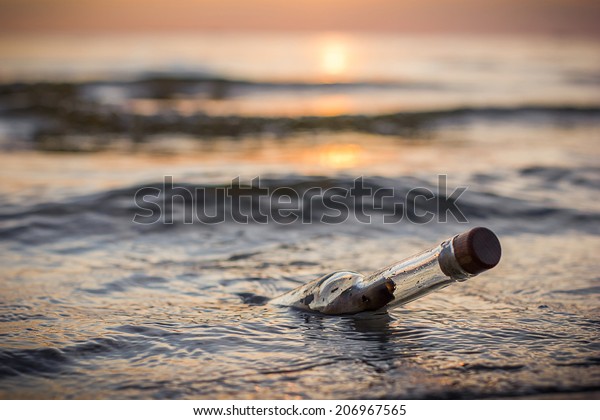 Message in a bottle in the\
sea sunset
