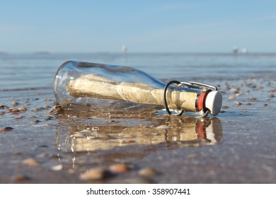 message in a bottle stranded on the beach