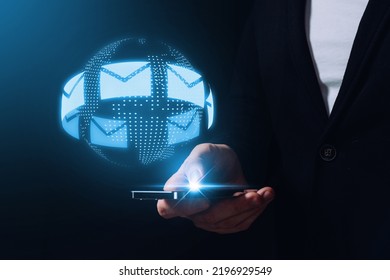 Message and email. Communication around the world via the Internet and instant messengers. The person is holding a smartphone with a hologram