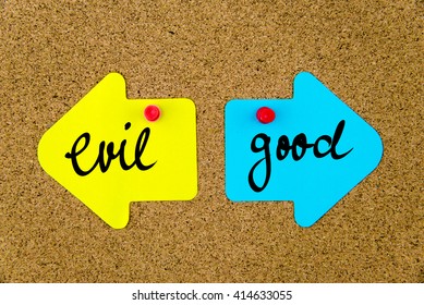 Message EVIL versus GOOD on yellow and blue paper notes as opposite arrows pinned on cork board with thumbtacks. Choice conceptual image