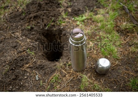 A message with a message for the future.A time capsule with a note.Bury the message in the ground.