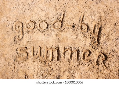 Message Lettering On The Yellow Sand Of The Beach Saying Goodbye Summer. Bright Contrasting Lateral Sunlight. Background. 