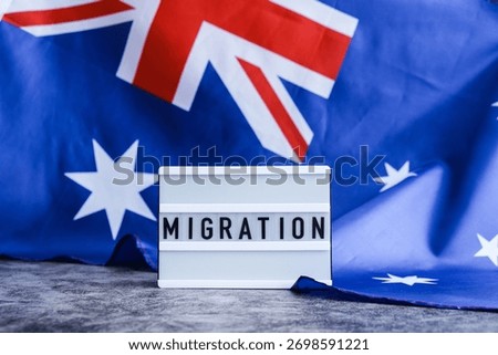 Message MIGRATION on background of Australian flag made from silk. Australia national flag with concept of tourism and traveling. welcoming