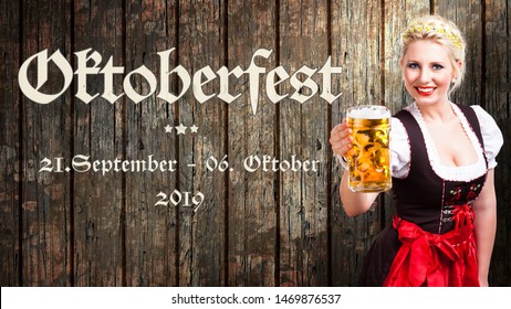 message "Oktoberfest - Sep 21. - Oct 06. 2019" in German beautiful woman in a traditional bavarian dirndl holding a beer in front of wooden background