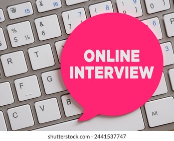 The message online interview on speech bubble over computer keyboard. Online job interview concept.