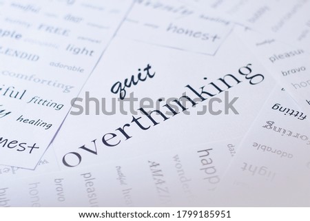 the message says quit overthinking surrounded by page sheets with positive words. Mental health awareness concept, selective focus.