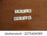 A message spelled out with letter tiles. Train wreck. A terrible train accident that damages property and endangers lives.