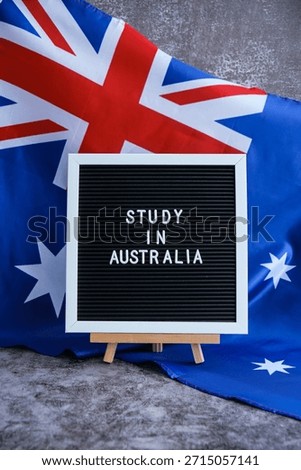 Message STUDY IN AUSTRALIA on background of Australian flag made from silk. Australia national flag with concept of tourism and traveling students opportunities scholarship programs 