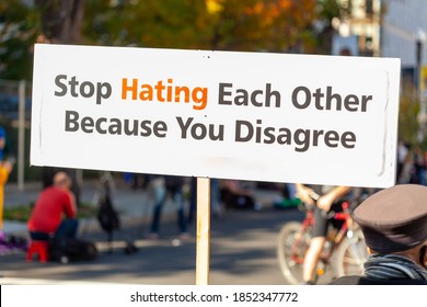 A message written on a banner placed in the street says: " Stop Hating Each Other Because You Disagree " . A peaceful slogan for tolerance to differing ideas and political views supporting harmony.
