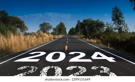 Message Year 2023 replaced by 2024 written on highway road in the middle of empty asphalt road beautiful blue sky. 
					Good bye 2023 - 2024 happy New Year coming concept.