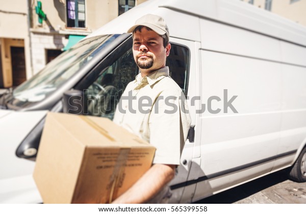 Messenger\
Delivering Parcel, Standing Next To His\
Van