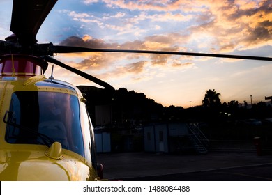 Messina, Italy - May 29 2019: Regional EMS Helicopter In  Service At Papardo Hospital. Sunset In The Background.