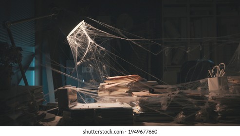 Messy Abandoned Office After Company Shut Down: The Desk Is Cluttered And Dusty, Financial Crisis Concept