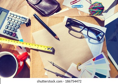 Messy Architect's Table With Work Tools