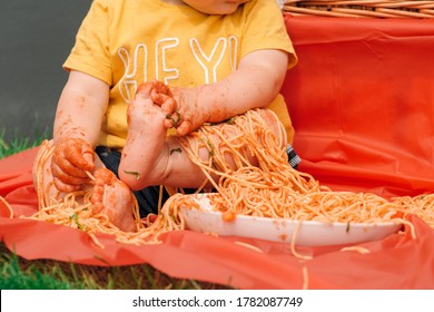 Messy Baby And A Bowl Of Spaghetti