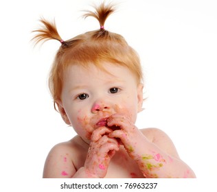 Messy Baby With Icing On Face And Hands