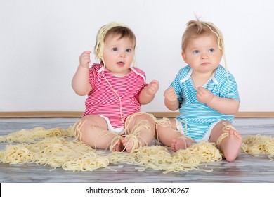 Messy Baby Toddlers Having Fun Eating Pasta  