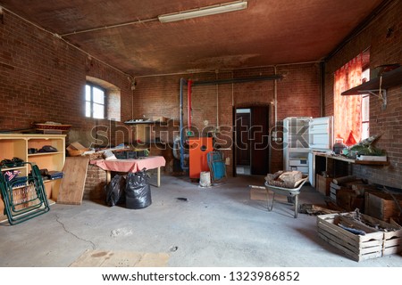 Messy basement with red bricks walls in old country house
